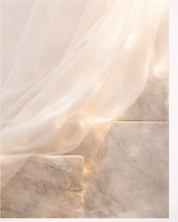 Sunlit silk falling across pale marble steps.